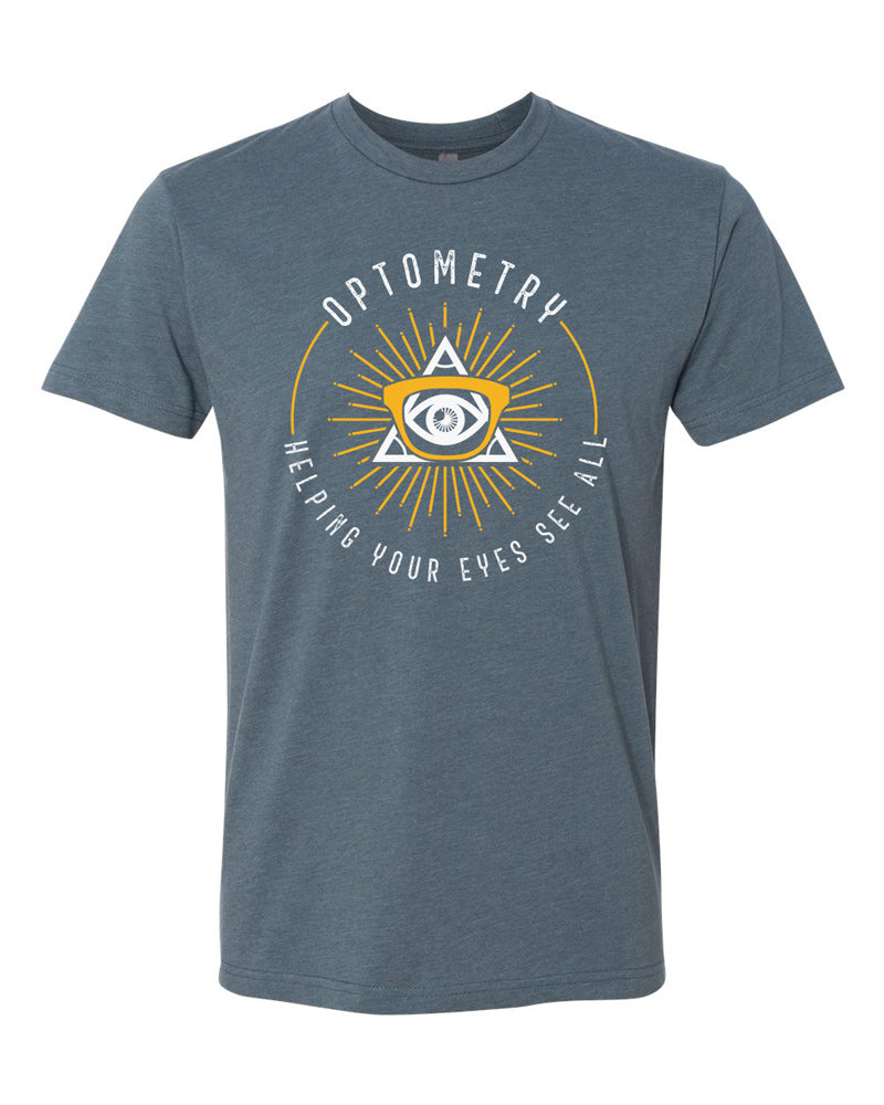 Indigo tee with white text reading "Optometry - Helping Your Eyes See All" arranged in a ring around a gold and white all-seeing eye with a monocular glasses frame over it.