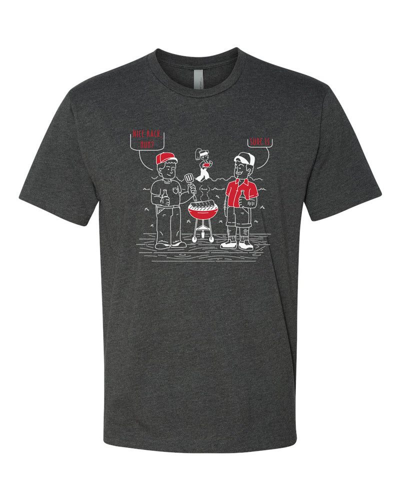 Charcoal tee with white and red imprint.  Cartoon shows two men around a grill, one is admiring a rack of ribs, the other, a woman in the background.  The first man says "Nice rack, huh," and the second agrees with "Sure is."