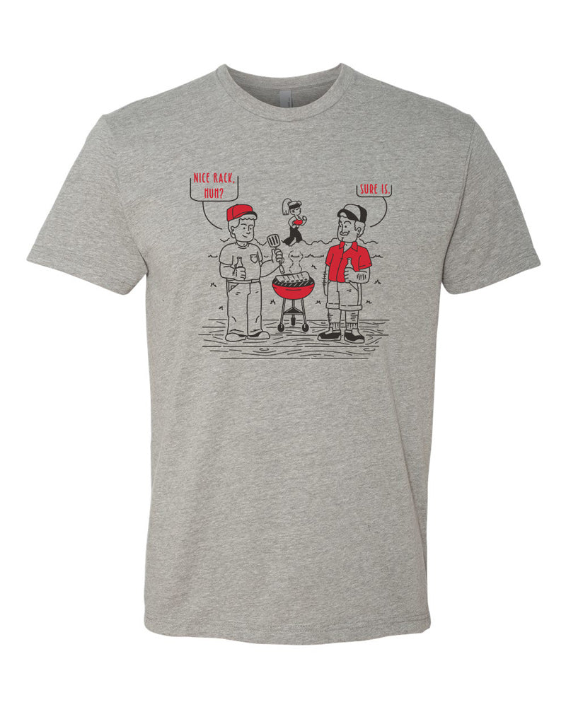 Dark heather tee with black and red imprint.  Cartoon shows two men around a grill, one is admiring a rack of ribs, the other, a woman in the background.  The first man says "Nice rack, huh," and the second agrees with "Sure is."