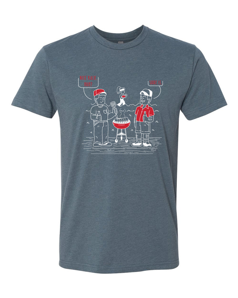 Indigo tee with white and red imprint.  Cartoon shows two men around a grill, one is admiring a rack of ribs, the other, a woman in the background.  The first man says "Nice rack, huh," and the second agrees with "Sure is."